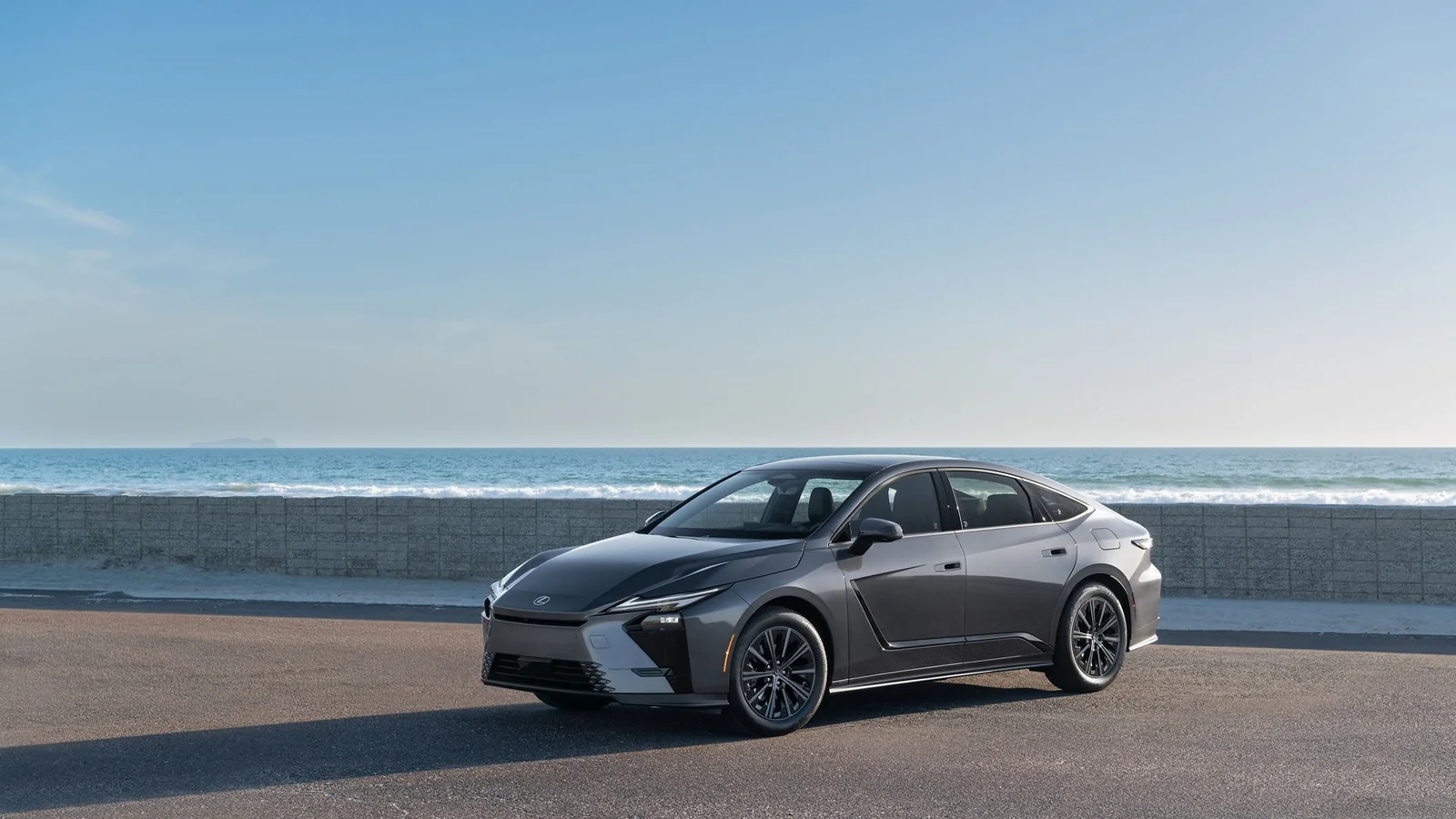 2027 Lexus ES 350h Premium in Cloudburst Gray, three-quarter view on a coastal road