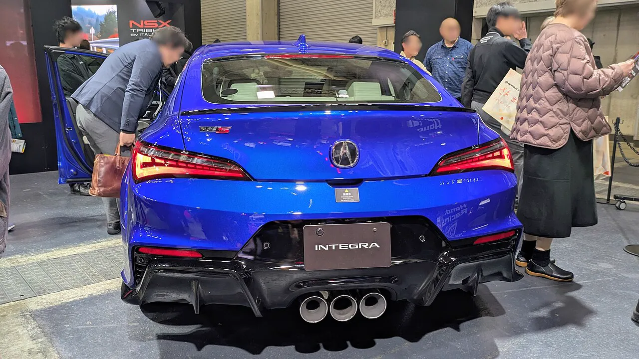 Rear three-quarter view of the Acura Integra Type S DE5, showing the wide rear fenders, aero elements, and Yokohama tires