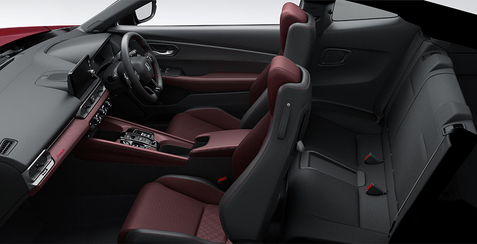 2027 Honda Prelude Limited Edition in Premium Crystal Garnet Metallic with red brake calipers and machined black 19-inch alloy wheels. Three-quarter rear view.