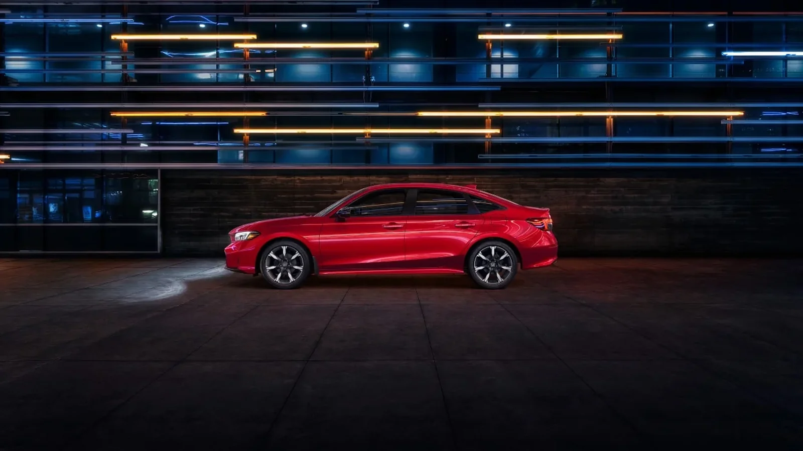 2026 Honda Civic Sedan in red, side profile at night, Canadian model